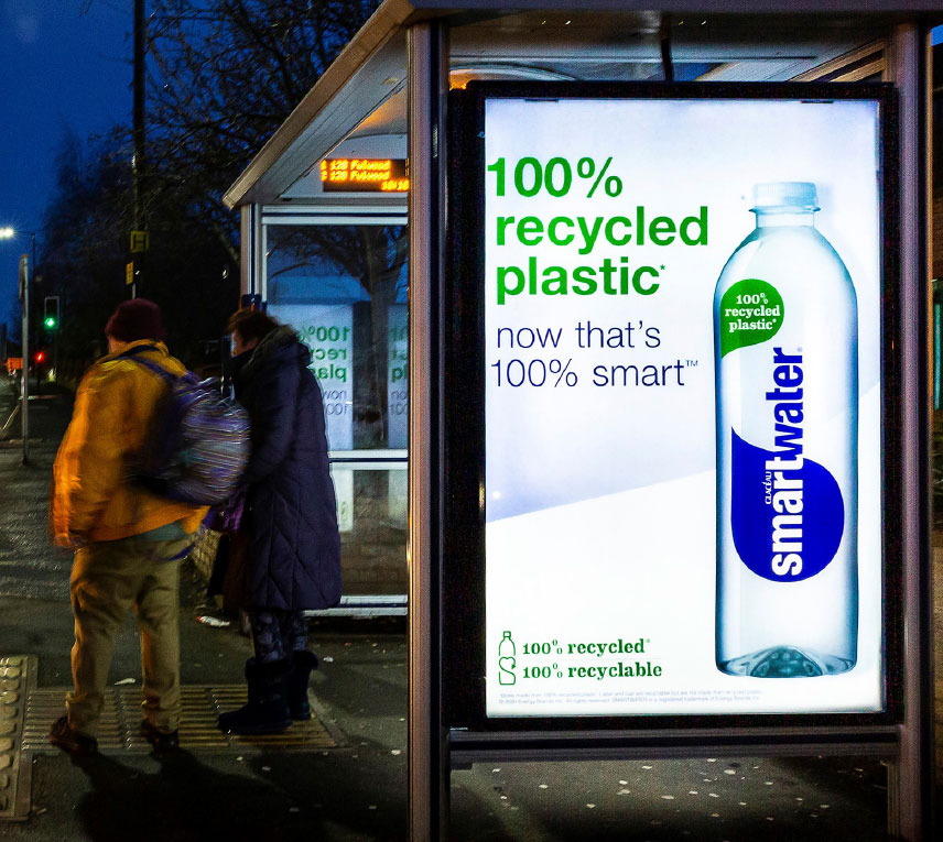 Advertisement poster on a bus stop at night